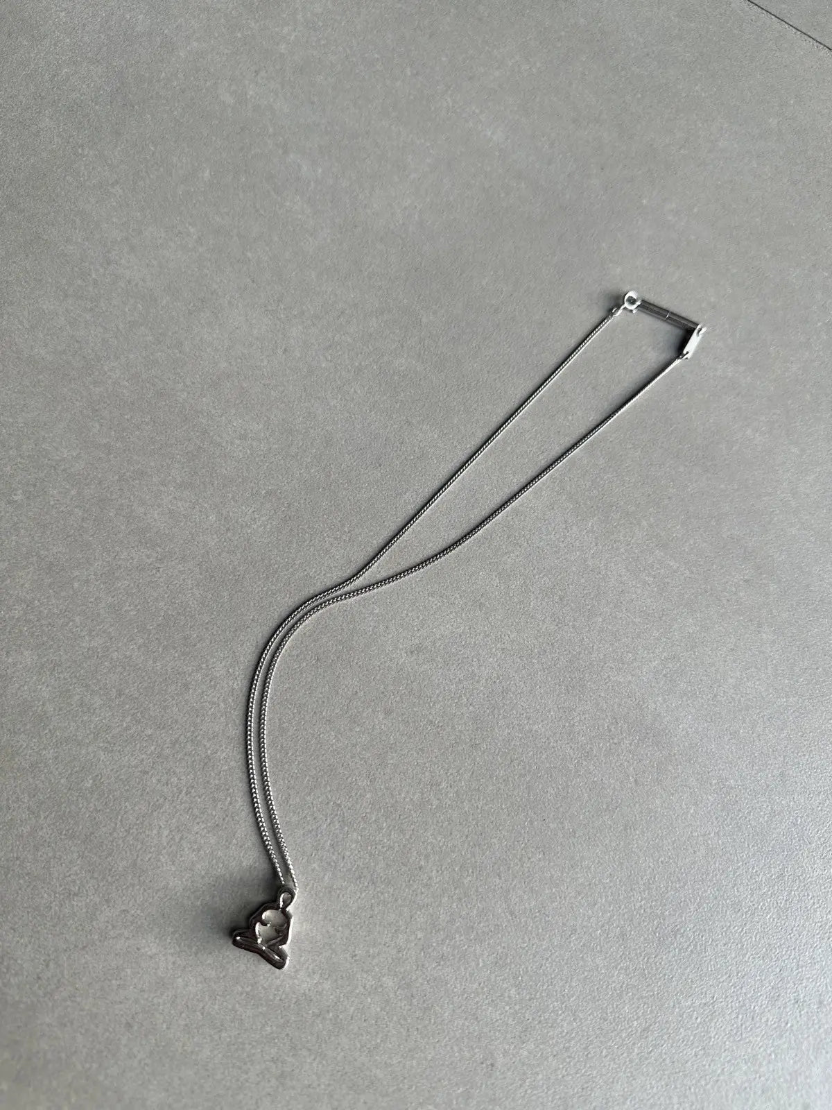 Dior homme SS03 “Follow me” Meditating figure necklace